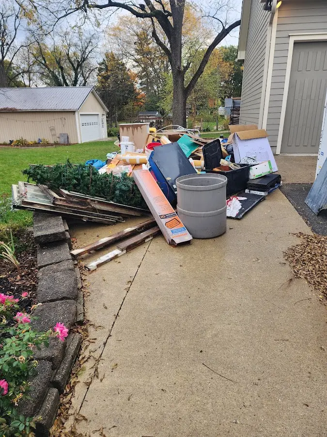 Dumpster being loaded with debris for Roofing Dumpster Rental in Freedom